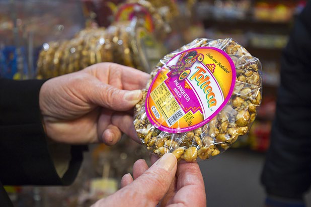 A customer holds a Mexican candy in Christy's Candy Shop at the Boulevard Mall Sunday, March 1, 2015.