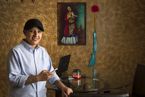 Army veteran Cristina Alfonso-Zea, 29, poses at her home Tuesday, March 3, 2015. Now employed in IT with a casino company, she previously served in Iraq and Afghanistan.