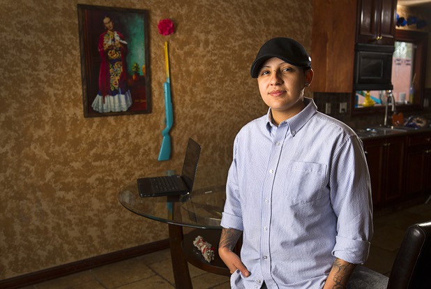 Army veteran Cristina Alfonso-Zea, 29, poses at her home Tuesday, March 3, 2015. Now employed in IT with a casino company, she previously served in Iraq and Afghanistan.