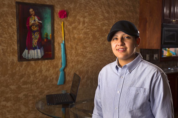 Army veteran Cristina Alfonso-Zea, 29, poses at her home Tuesday, March 3, 2015. Now employed in IT with a casino company, she previously served in Iraq and Afghanistan.