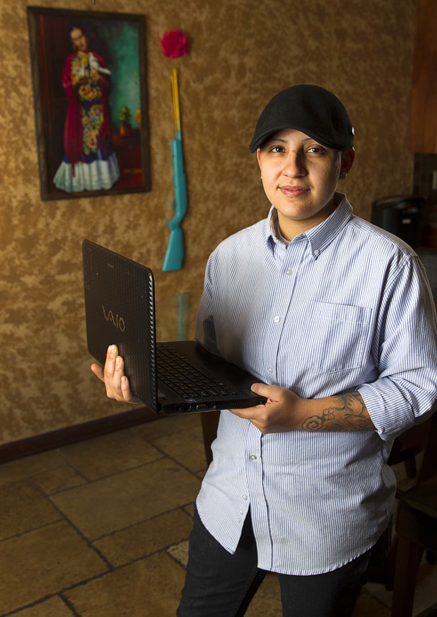 Army veteran Cristina Alfonso-Zea, 29, poses at her home Tuesday, March 3, 2015. Now employed in IT with a casino company, she previously served in Iraq and Afghanistan.