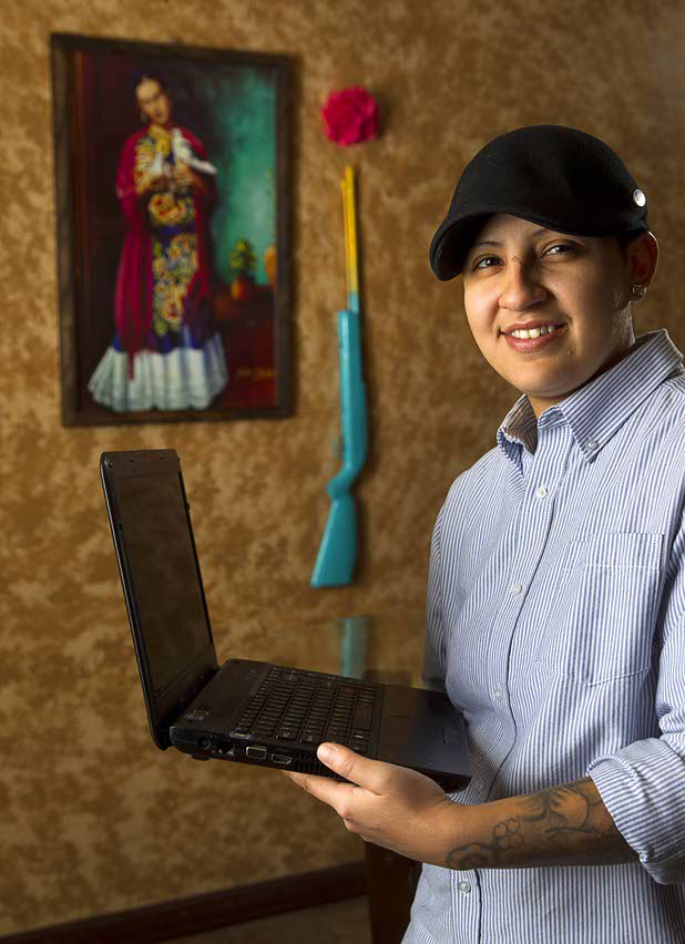 Army veteran Cristina Alfonso-Zea, 29, poses at her home Tuesday, March 3, 2015. Now employed in IT with a casino company, she previously served in Iraq and Afghanistan.