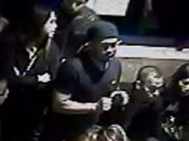 Metro Police identified this person (in cap, center of photo) as a suspect in the Feb. 22, 2015, stabbing of two people the parking lot of a restaurant in the 4000 block of Spring Mountain Road.