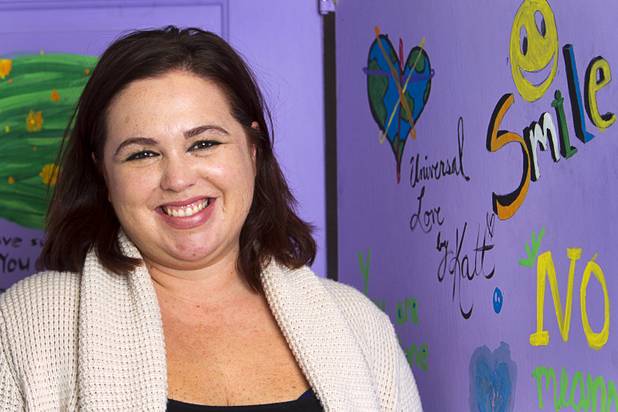 Christina Hernandez, director of the Jean Nidetch Women's Center at UNLV, poses at the center Friday, March 6, 2015. The purple doors are an art piece created during a "Take Back the Night" event in 2013. 