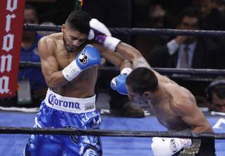 Abner Mares, left, of Guadalajara, Mexico, fights Arturo Santos Reyes of Nuevo Laredo, Mexico, during their featherweight match in the Premier Boxing Champions event at MGM Grand Garden Arena on Saturday, March 7, 2015.