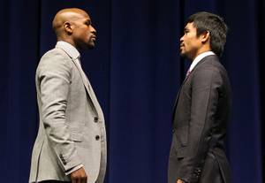 Boxers Floyd Mayweather Jr. and Manny Pacquiao face off during a news conference at Nokia Theater on Wednesday, March 11, 2015, in Los Angeles. The welterweights are scheduled to fight Saturday, May 2, at MGM Grand Garden Arena in Las Vegas.