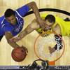 Kentucky's Marcus Lee, left, and Michigan's Jordan Morgan go after a rebound during the first half of an NCAA Midwest Regional final college basketball tournament game Sunday, March 30, 2014, in Indianapolis.