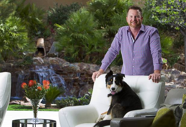 Tim Haughinberry, founder of Back Bar USA, a marketing and supply firm for nightlife industry, poses with Archie, a one-year-old Border Collie, at his home in Henderson Sunday, March 15, 2015.