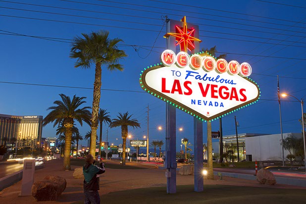 A man takes a photograph of the Welcome to Fabulous Las Vegas sign Saturday, March 14, 2015, on the Strip.