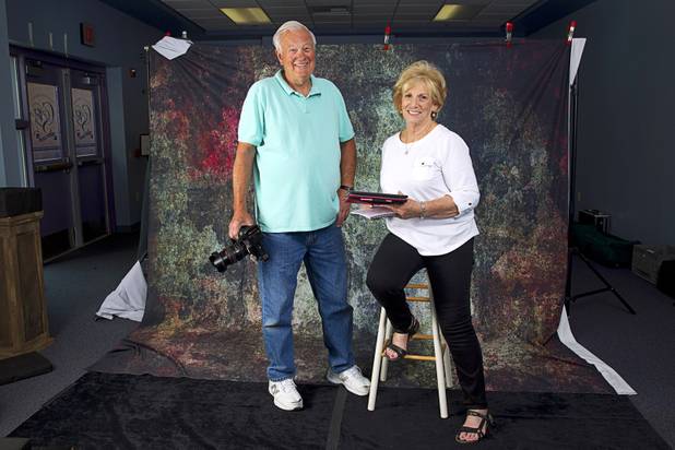 Jim and Anita Ziegler of Sandstone Photography pose during a portrait session for graduating seniors at Canyon Springs High School in North Las Vegas Tuesday, March 17, 2015. The Zieglers volunteer their time to take free photos of selected graduating seniors who otherwise can't afford to have them taken.