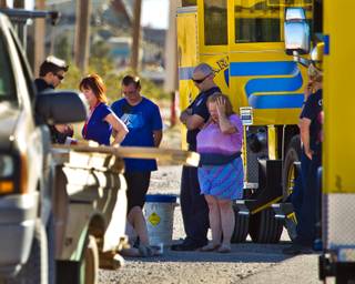 Family members and supporters gather with Clark County rescue personnel along S. Las Vegas Blvd. and Sloan Road following a glider crash with the death of an 11-year-old boy south of there on Friday, March, 27, 2015.
