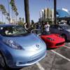 This Dec. 13, 2013 file photo shows from left, electric cars from Nissan, Tesla and Toyota presented at a news conference in Los Angeles. Mayor Eric Garcetti unveiled a plan on Wednesday, April 8, 2015, designed to make Los Angeles a more green and liveable city. 