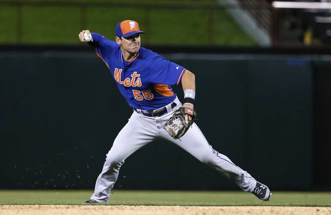 New York Mets prospect Matt Reynolds throws to first during a spring training game Friday, April 3, 2015, in Arlington, Texas.