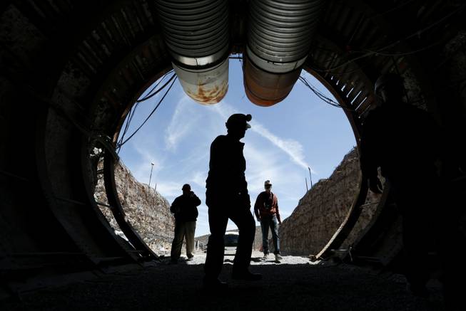 People walk into the south portal of Yucca Mountain during a congressional tour Thursday, April 9, 2015, near Mercury. Several members of Congress toured the proposed radioactive waste dump 90 miles northwest of Las Vegas. 