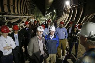 People stand inside of Yucca Mountain during a congressional tour Thursday, April 9, 2015, near Mercury, Nev. Several members of congress toured the proposed radioactive wast dump 90 miles northwest of Las Vegas. (AP Photo/John Locher)