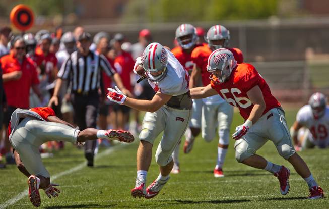 UNLV football player Antonio Zepeda (87) shakes off defenders during the Spring Showcase, the last official gathering for the Rebels and coach Tony Sanchez before August on Saturday, April 18, 2015.