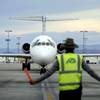 In this Thursday, May 9, 2013, photo, an airline ground worker guides an incoming Allegiant Air jetliner at McCarran International Airport in Las Vegas.