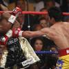 Manny Pacquiao, from the Philippines, right, hits Floyd Mayweather Jr. during their welterweight title fight on Saturday, May 2, 2015 in Las Vegas.