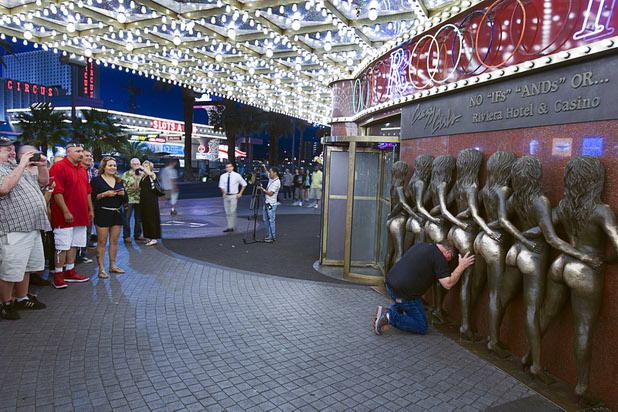 8:04 p.m. - A man poses for a photo in front of the Crazy Girls sculpture at the Riviera Sunday, May 3, 2015.  STEVE MARCUS