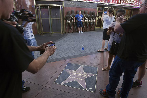 8:06 p.m. - People take photos in front of the Riviera on the final night of operation Sunday, May 3, 2015.