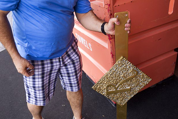 10:04 a.m. - A worker removes door handles before the closing at the Riviera Monday, May 4, 2015.  STEVE MARCUS