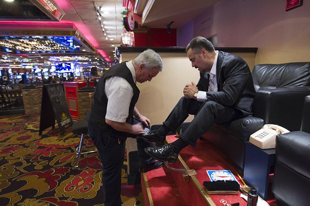 10:26 a.m. - Fernando Formoso of White Plains, N.Y., gets a shoe shine from Glenn Comeau at the Riviera on Monday, May 4, 2015.  