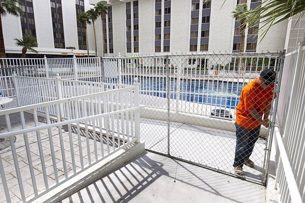 10:29 a.m. - A worker fences off the Riviera pool Monday, May 4, 2015.  STEVE MARCUS