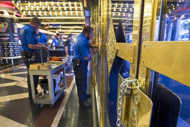 12:01 p.m. - A security officer puts chains on the front doors of the Riviera Monday, May 4, 2015. The 60-year-old Riviera, which was the Las Vegas Strips first high-rise property, will be imploded to make way for a $2.3 billion convention center business district facility. STEVE MARCUS