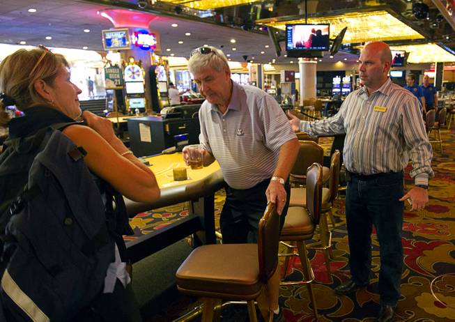 12:11 p.m. - Riviera slot director Chuck Palermo, right, tells a couple that is time to leave as the Riviera closes Monday, May 4, 2015. 