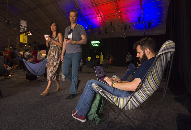 Raul Troyo Alvarez, right, of Filestory connects with co-workers during the Collision technology conference at the World Market Center Pavilions Wednesday, May 6, 2015. Filestory is a file management software company, he said.