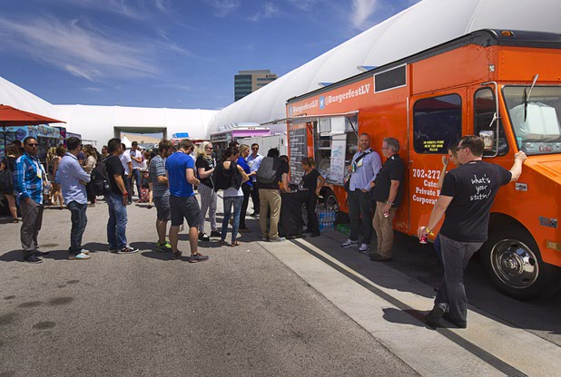 Attendees line up at food trucks for lunch during the Collision technology conference at the World Market Center Pavilions Wednesday, May 6, 2015.