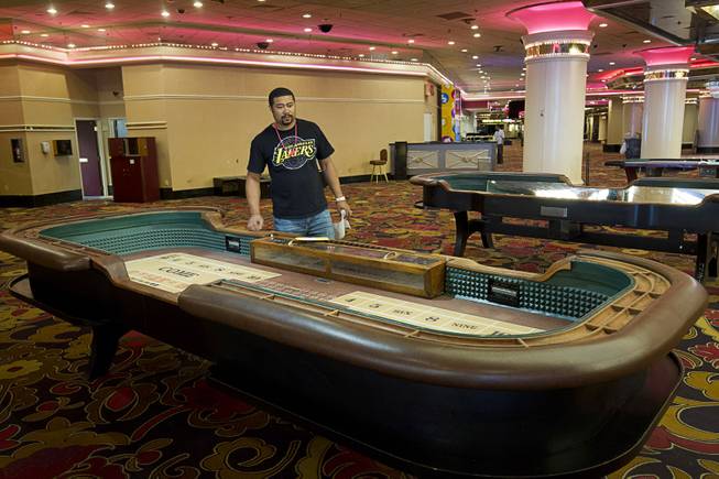 Lamar Hutch of Conyers, Ga. looks over a craps table ($3,850.00) during the first day of a liquidation sale at the Riviera Thursday, May 14, 2015.