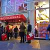 In this Nov. 21, 2011, file photo, shoppers stand outside FAO Schwarz in New York. Toys R Us is closing its iconic FAO Schwarz store, citing high and rising costs of running the retail space on New York City's pricey Fifth Avenue, the company said Friday, May 15, 2015. 