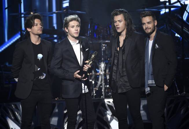 From left, Louis Tomlinson, Niall Horan, Harry Styles and Liam Payne of One Direction accept the award for top duo/group at the Billboard Music Awards at MGM Grand Garden Arena on Sunday, May 17, 2015, in Las Vegas.