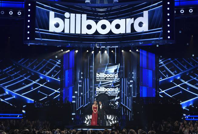 Hosts Chrissy Teigen, left, and Ludacris speak at the Billboard Music Awards at MGM Grand Garden Arena on Sunday, May 17, 2015, in Las Vegas.