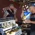 Dane Mentzer, left, the founder and CEO of Tusk & Hide Trading Co., talks with customer Elisha Quick at his booth in a vendor area of the Punk Rock Bowling & Music Festival in downtown Las Vegas Monday, May 25, 2015.