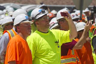 Workers take video on their phones as the final steel beam is lifted into place during a topping off ceremony for the Las Vegas Arena Wednesday, May 27, 2015. Representatives from MGM Resorts International and AEG, contractors Hunt-Penta and elected officials were on hand to celebrate the installation of the arena's final steel beam. The $375 million arena is scheduled to open in Spring 2016.