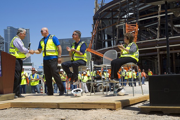 Clark County Commission Chairman Steve Sisolak, left, shakes hands with Mark Prows, senior vice president of arenas for MGM Resorts International, during a topping off ceremony for the Las Vegas Arena Wednesday, May 27, 2015. Looking on is Mark Faber, senior vice president, Global Partnership, AEG, and Commissioner Mary Beth Scow. The $375 million arena is scheduled to open in Spring 2016.