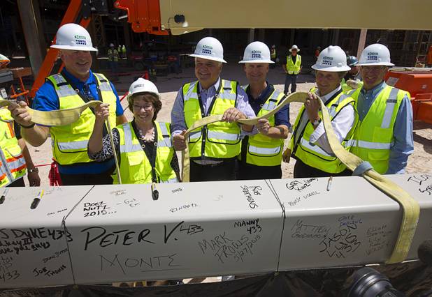 Representatives from MGM Resorts International and AEG, contractors Hunt-Penta and elected officials pose with the final beam during a topping off ceremony for the Las Vegas Arena Wednesday, May 27, 2015. The $375 million arena is scheduled to open in Spring 2016.