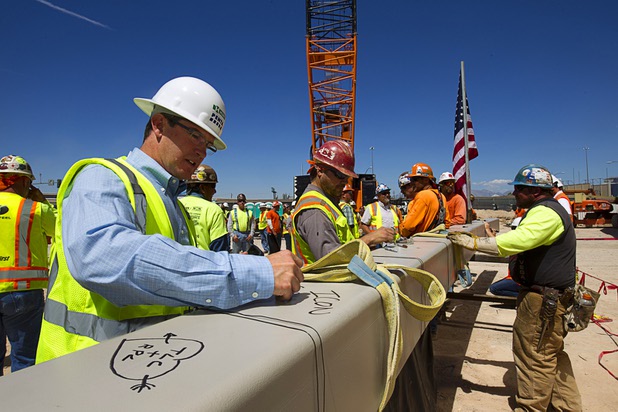 Tim Romani, of the Icon Venue Group signs the final steel beam during a topping off ceremony for the Las Vegas Arena Wednesday, May 27, 2015. Representatives from MGM Resorts International and AEG, contractors Hunt-Penta and elected officials were on hand to celebrate the installation of the arena's final steel beam. The $375 million arena is scheduled to open in Spring 2016.