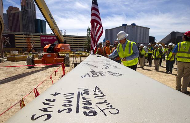 People sign the final steel beam during a topping off ceremony for the Las Vegas Arena Wednesday, May 27, 2015. Representatives from MGM Resorts International and AEG, contractors Hunt-Penta and elected officials were on hand to celebrate the installation of the arena's final steel beam. The $375 million arena is scheduled to open in Spring 2016.