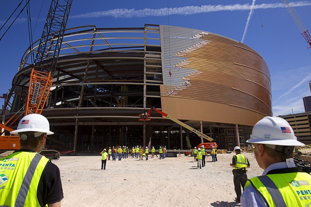 Workers gather around the final steel beam during a topping off ceremony for the Las Vegas Arena on Wednesday, May 27, 2015. Representatives from MGM Resorts International and AEG, contractors Hunt-Penta and elected officials were on hand to celebrate the installation of the arena's final steel beam. The $375 million arena is scheduled to open in Spring 2016.