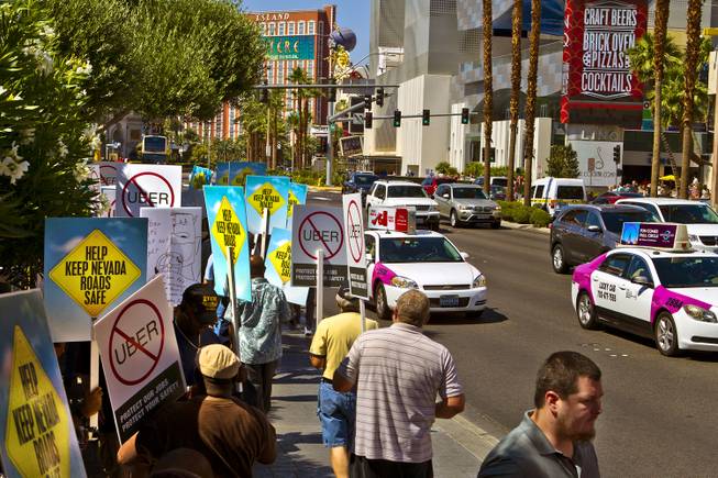 Taxi cab drivers gather on the Strip in front of Caesars Palace to protest Uber, the competing ride sharing program trying to break into the Las Vegas market on Friday, May 29, 2015. 