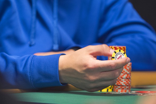 Las Vegas Sun reporter Case Keefer plays with a poker chip as he competes in the $565 buy-in "Colossus" event during the World Series of Poker at the Rio Monday, June 1, 2015.
