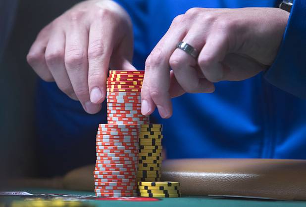 Las Vegas Sun reporter Case Keefer stacks his chips as he competes in the $565 buy-in "Colossus" event during the World Series of Poker at the Rio Monday, June 1, 2015.