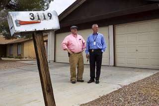 Metro Police Detectives Barry Jensen, left, and Marty Wildemann stand in front of a rental home in a neighborhood near Pecos Road and Harmon Avenue Tuesday, June 9, 2015. Abby Roberts and her boyfriend Phillip Johnson disappeared from the home on Sept. 29, 2012. On Oct. 3, 2012, Johnson dropped off his son and Robert's two-month-old son with relatives in California. His car was later found abandoned.