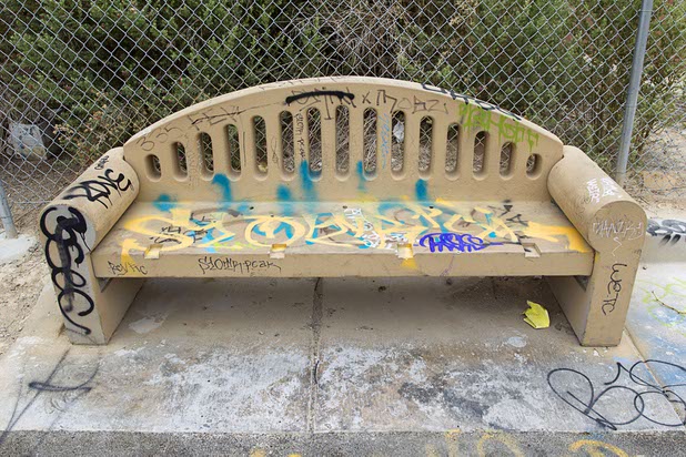 A bench is covered in graffiti along the Las Vegas Wash channel near Pecos Road and Lake Mead Boulevard Tuesday, June 9, 2015.