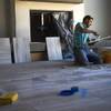 Eric Camacho works on a tile floor at a Christopher Homes construction site Thursday, June 11, 2015, in the Ridges Las Vegas, a luxury residential community in Summerlin.