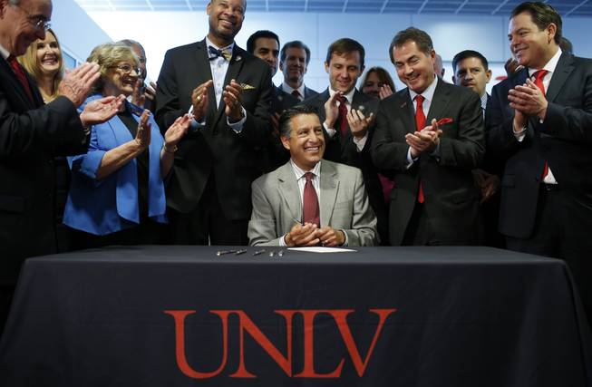 Nevada Gov. Brian Sandoval signs SB 514 into law at UNLV on Thursday, June 11, 2015, in Las Vegas. The bill authorizes $27 million for the UNLV School of Medicine.