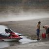 People prepare to launch watercraft as wind kicks up dust on an area that was once under water at Boulder Harbor boat ramp in Lake Mead National Recreation Area on Monday, May 18, 2015, near Boulder City.